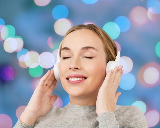 A woman listening to meditation music on headphones