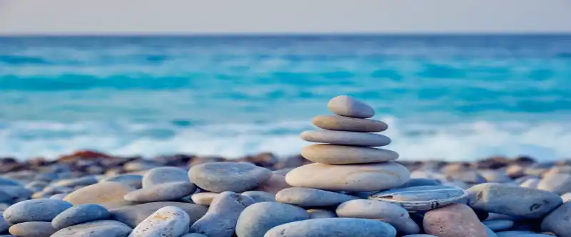 Beach stones and relaxing nature scene. Relaxing nature sounds are part of the incredible healing sounds used in meditation music @ i-am-meditations.com