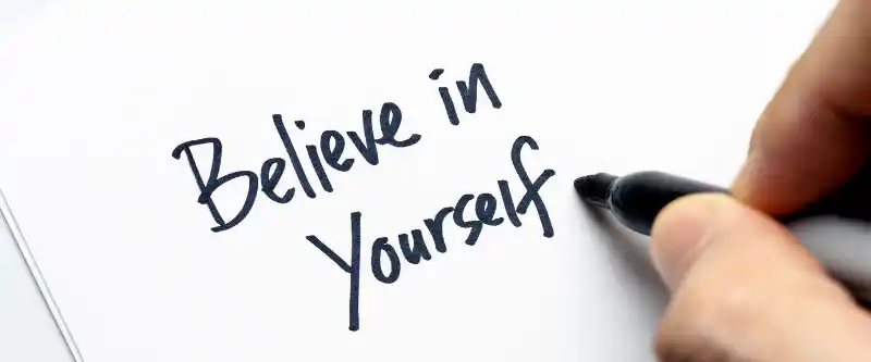 Believe in yourself. A hand writing text with the phrase believe in yourself. Find out how to believe in you @ i-am-meditations.com