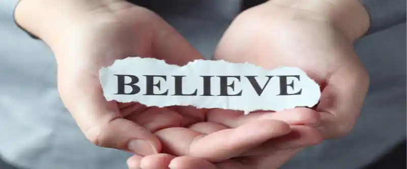 Hand holding a sign that says "Believe" as part of the process of believing in yourself. Find out how to believe in yourself @ i-am-meditations.com