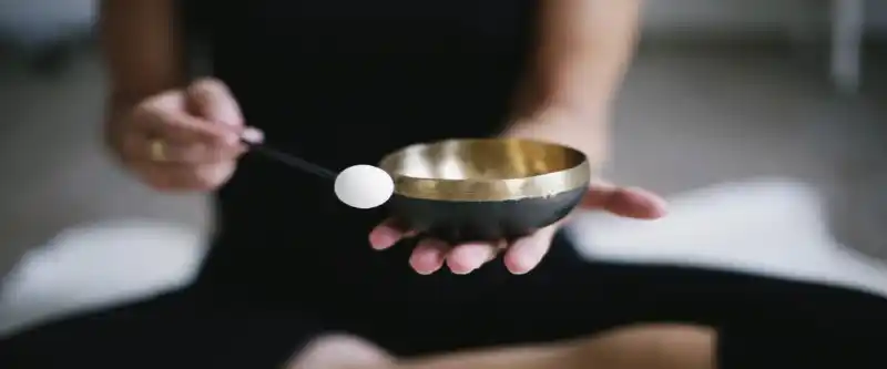 A black singing bowl played on hand, as part of the revolutionary healing frequency meditation music. the highest quality of music for meditation made with singing bowls @ i-am-meditations.com