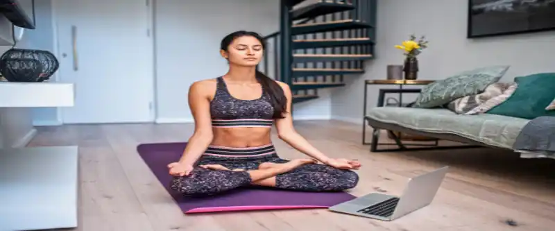 Female meditating on a yoga mat and activating The Law of Attraction. Learn how to use LOA yourself @ i-am-meditations.com