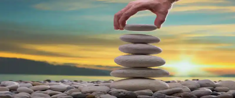 Stacking peddle stones by the beach as part of meditation for anxiety. Meditation for anxiety is a great tool to help you deal with stress. Learn the specific i AM Meditation technique @ i-am-meditations.com