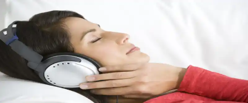 Listening to meditation music on headphones. Ripping the benefits of relaxation music, and professionally designed sound healing sessions @ i-am-meditations.com