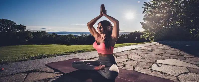 A woman meditating while listening to meditation instructions. Explore the various methods of meditation @ i-am-meditations.com